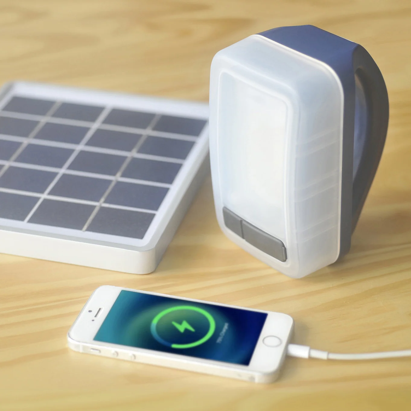 IONA ECO COMFORT lantern beside a solar panel and a connected smartphone