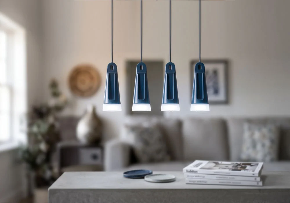 Four slender High Dome hanging lights arranged above a table