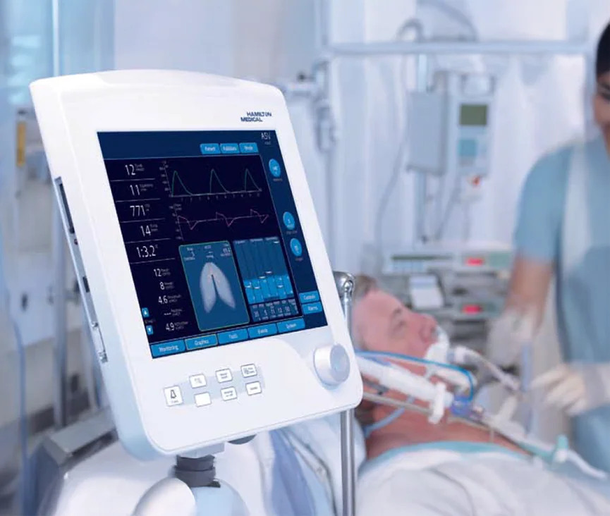 Hamilton Medical ventilator interface shown beside a patient in an intensive-care setting
