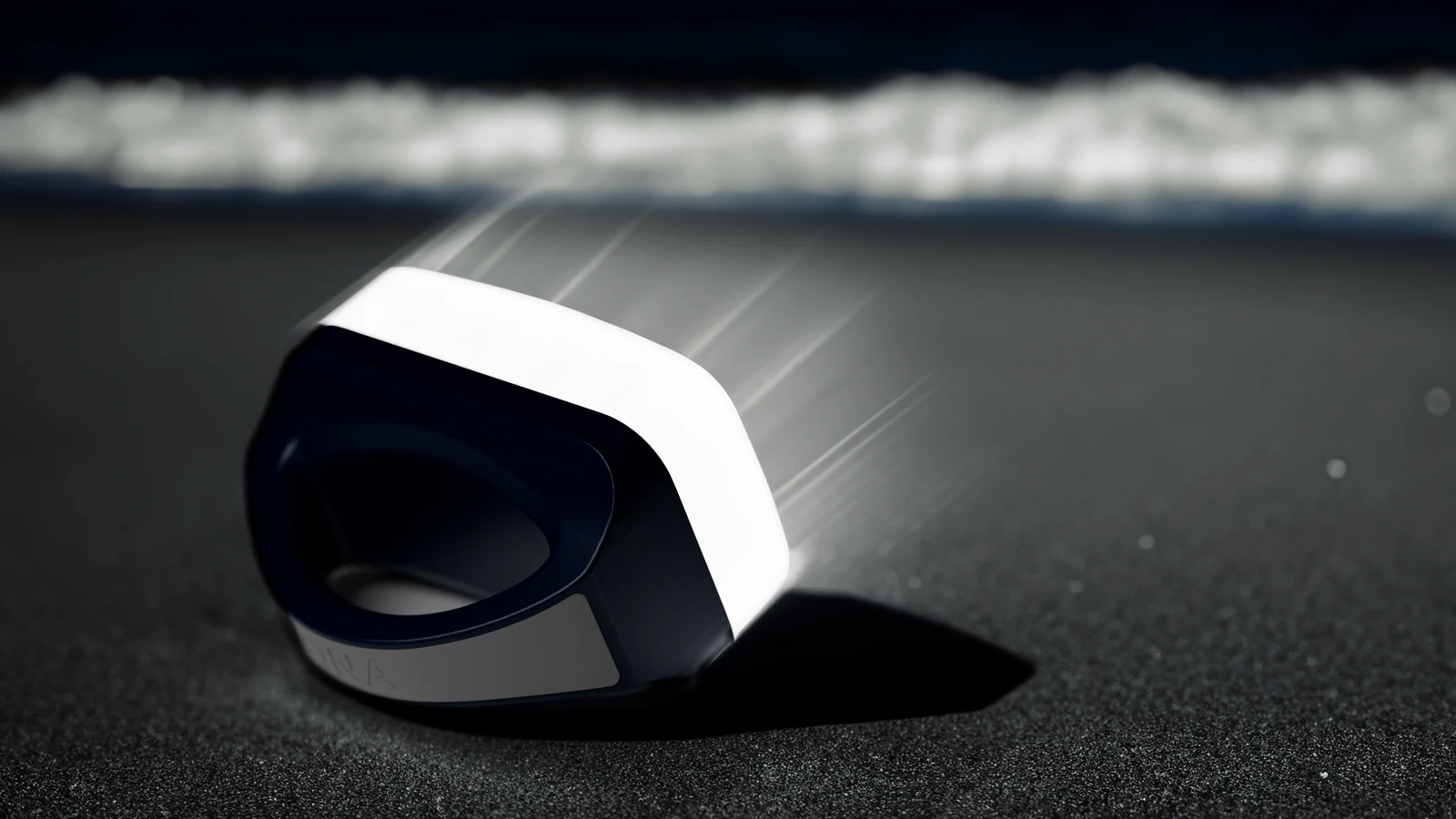 IONA ECO COMFORT solar lantern photographed with water droplets on a dark beach