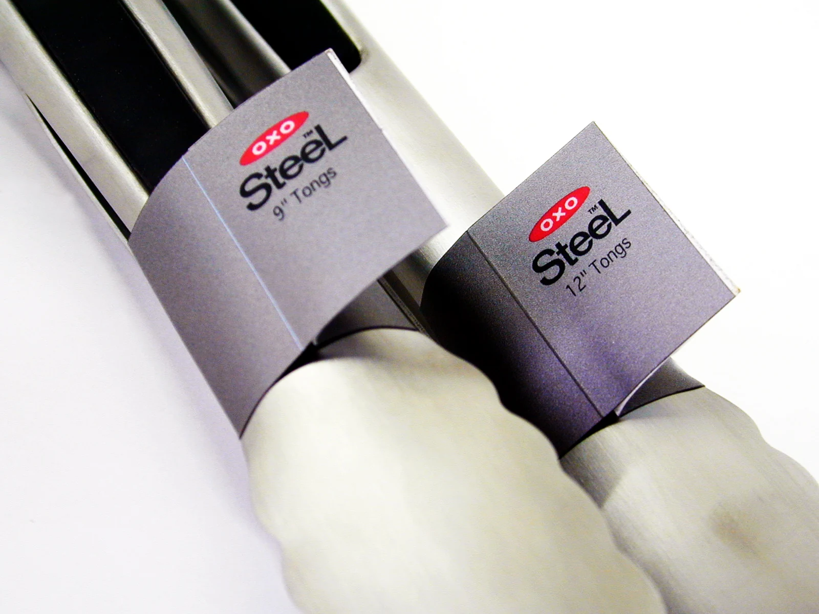 OXO STEEL tongs in their original 9-inch and 12-inch packaging
