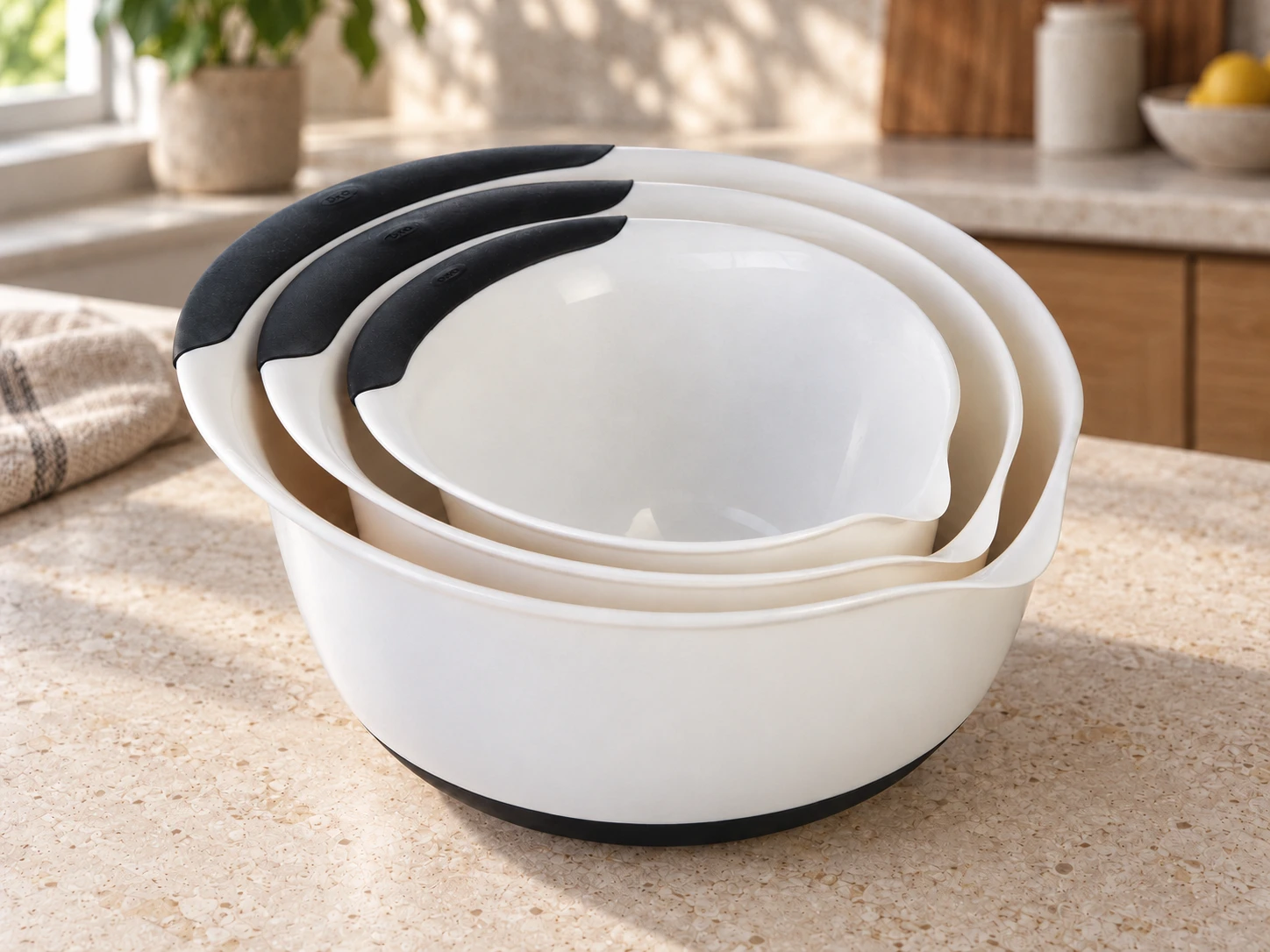 Three OXO Good Grips mixing bowls nested on a kitchen worktop, viewed from the side